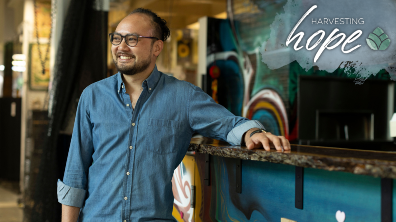 Tony Vu smiles at his Flint Social Club stand at the Flint Farmer's Market.